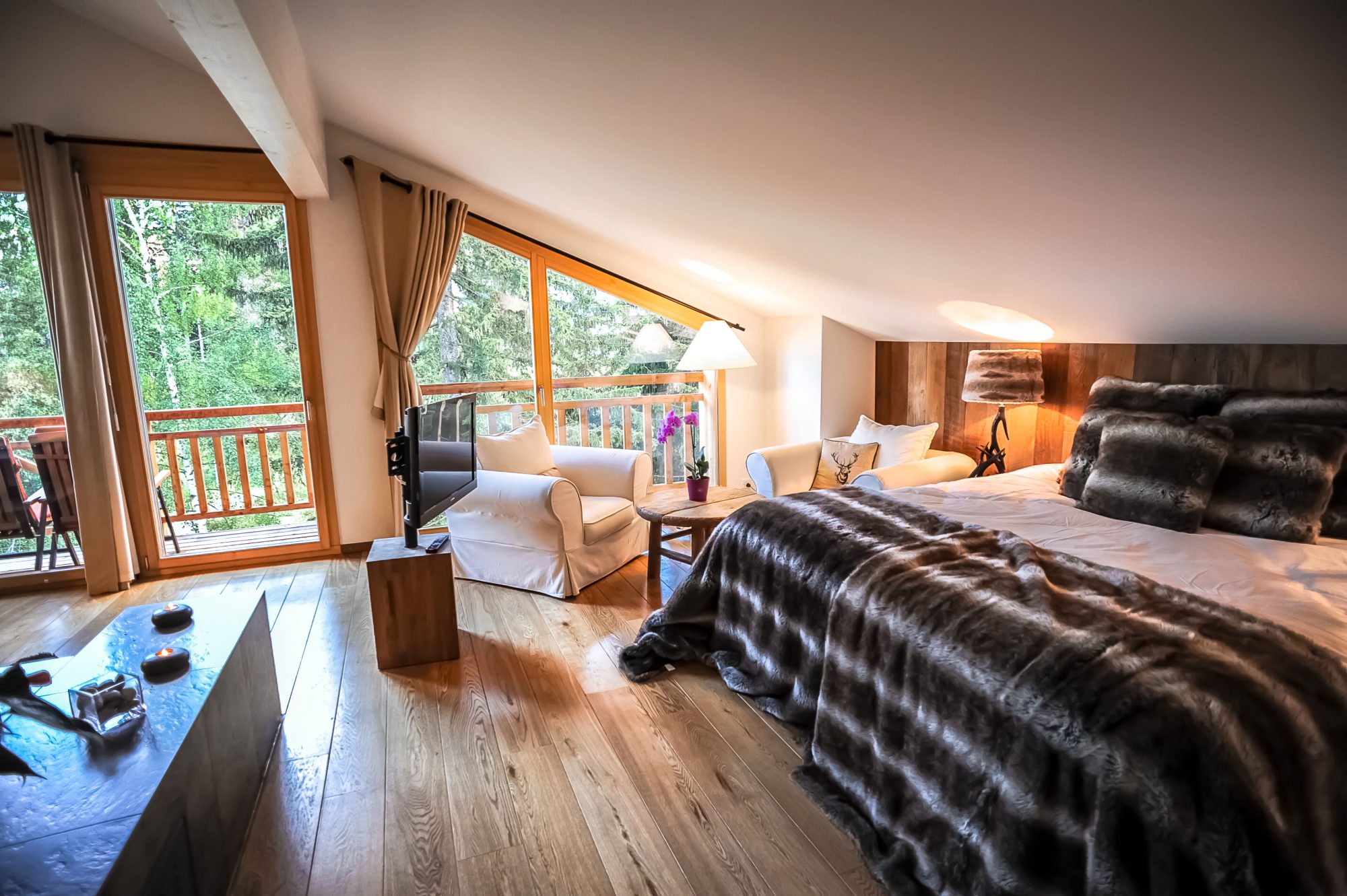 Bedroom with a view at one of Crans Luxury Lodges