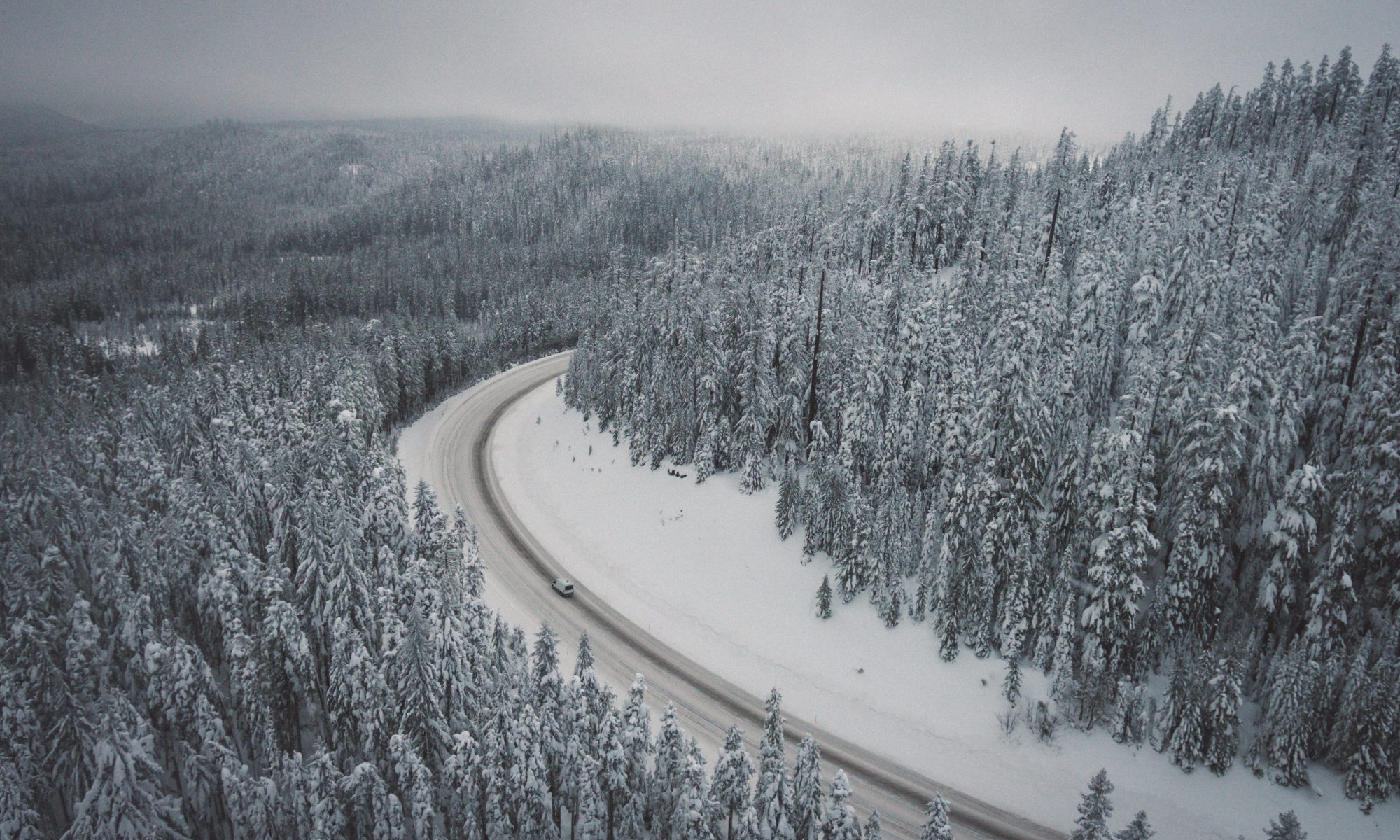 Driving with snow- check if you need snow tyres and/or snow chains. Photo Adrian- Unsplash. Skiers Face Winterisation and Ski Rack Charges Adding up to £179 On Car Hire Bill.