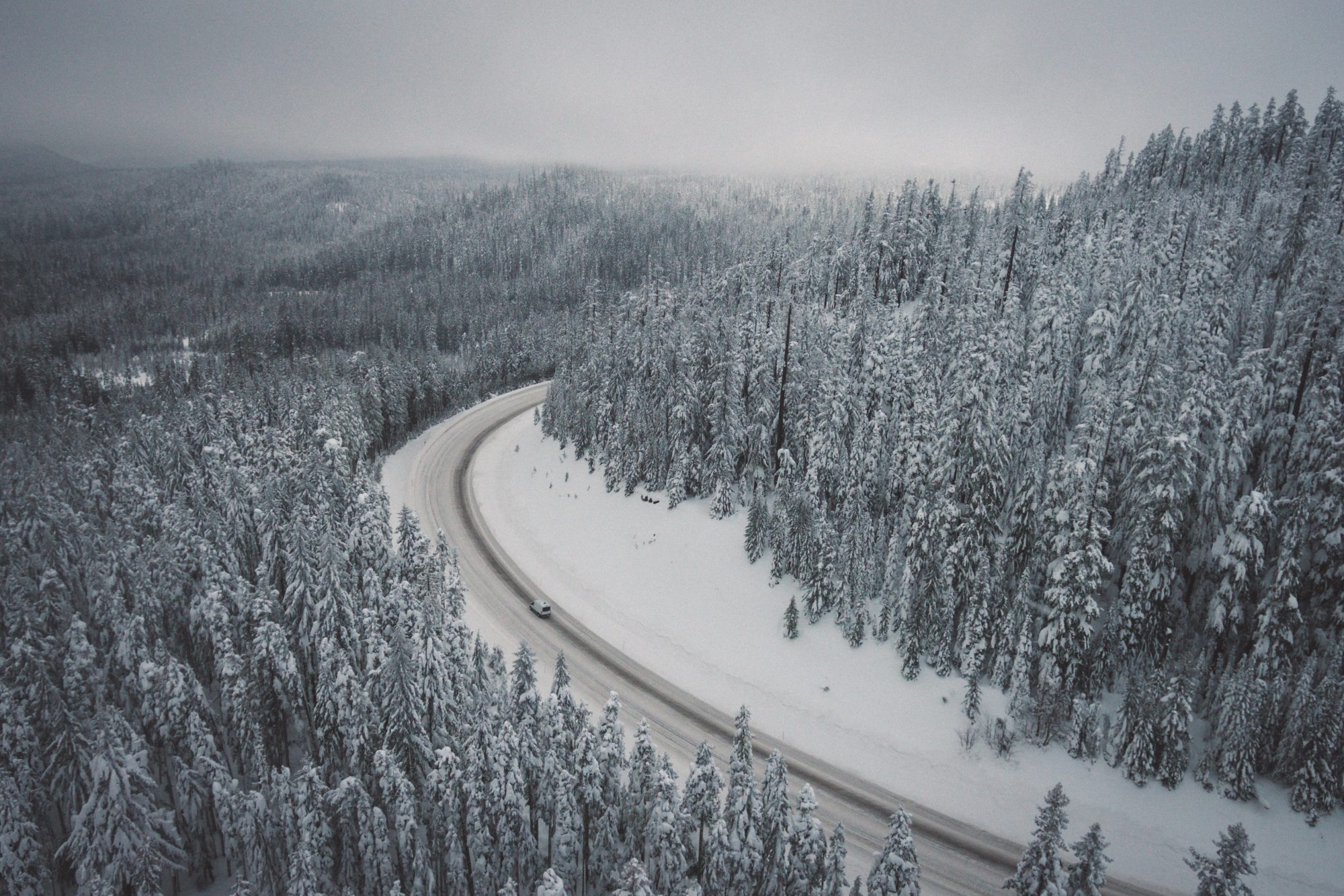 Driving with snow- check if you need snow tyres and/or snow chains. Photo Adrian- Unsplash- Driving to the mountains - winter tyres, snow chains.