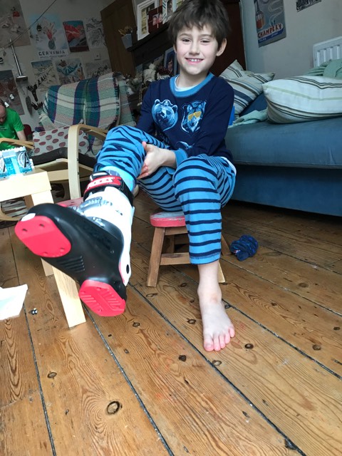 My kid is excited with his new ski boots!