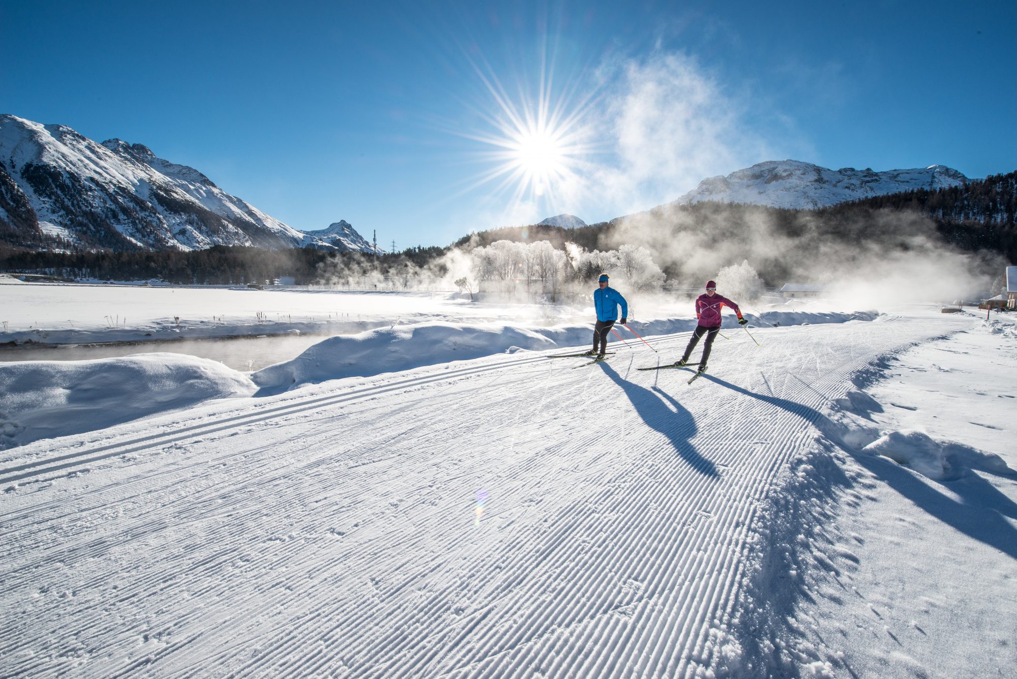 ENGADIN ST. MORITZ - Cross country skiers skating along the ski trail between Celerina and Samedan, with the Piz Albris (3166m) in the background. Copyright by: ENGADIN St. Moritz By-line: swiss-image.ch/Romano Salis