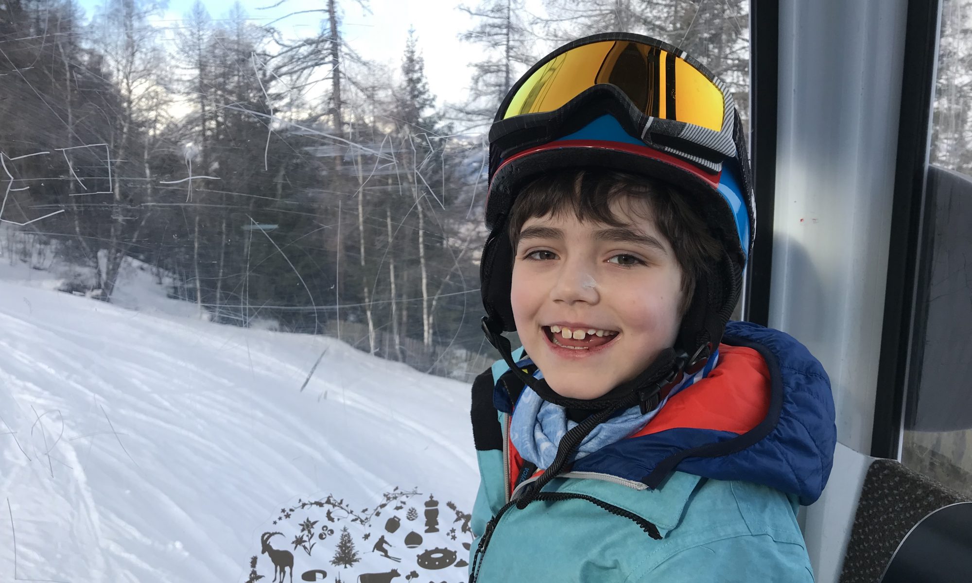 Going up the gondola, one happy child - Photo by The-Ski-Guru - Pila, Aosta Valley.