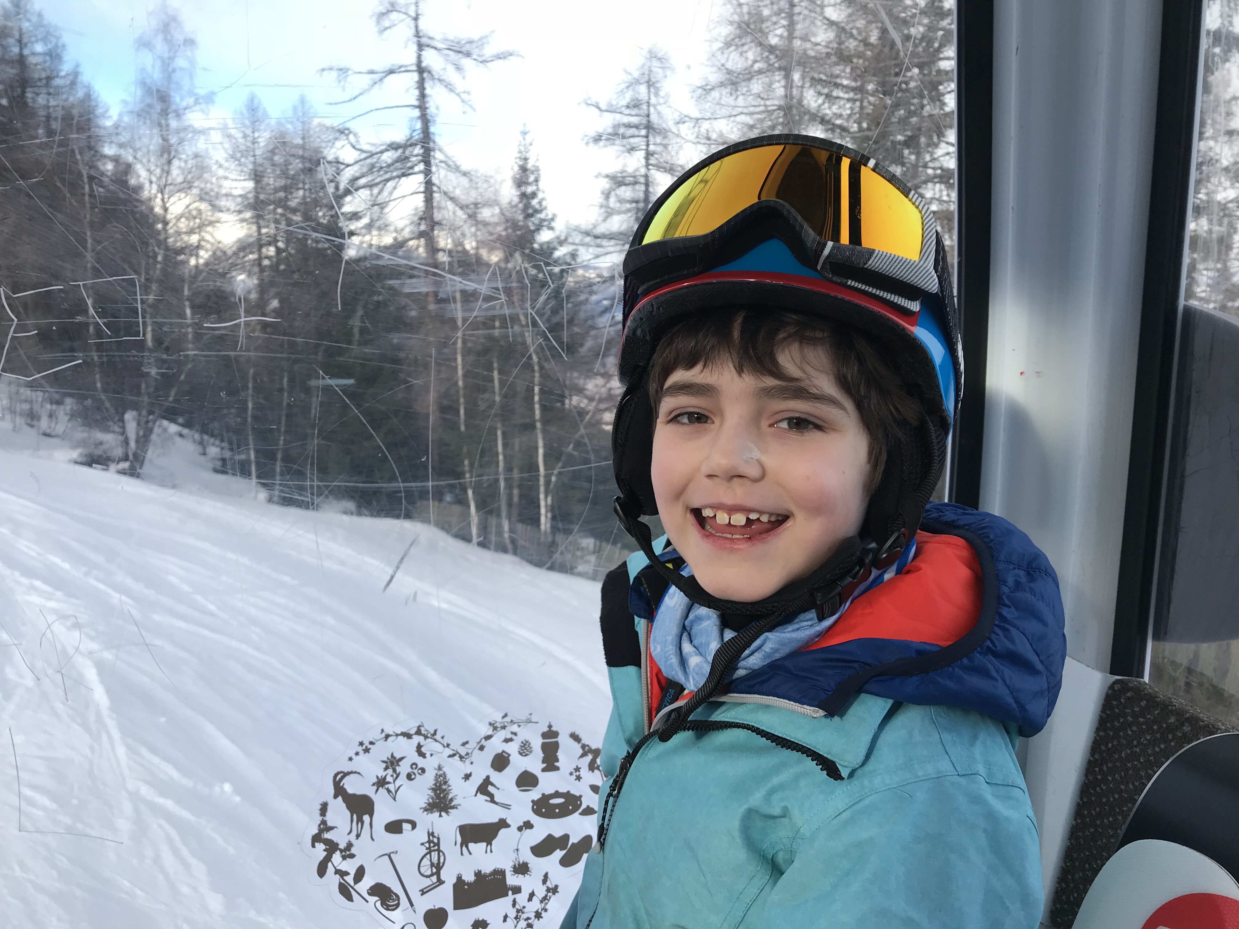 Going up the gondola, one happy child - Photo by The-Ski-Guru - Pila, Aosta Valley. 