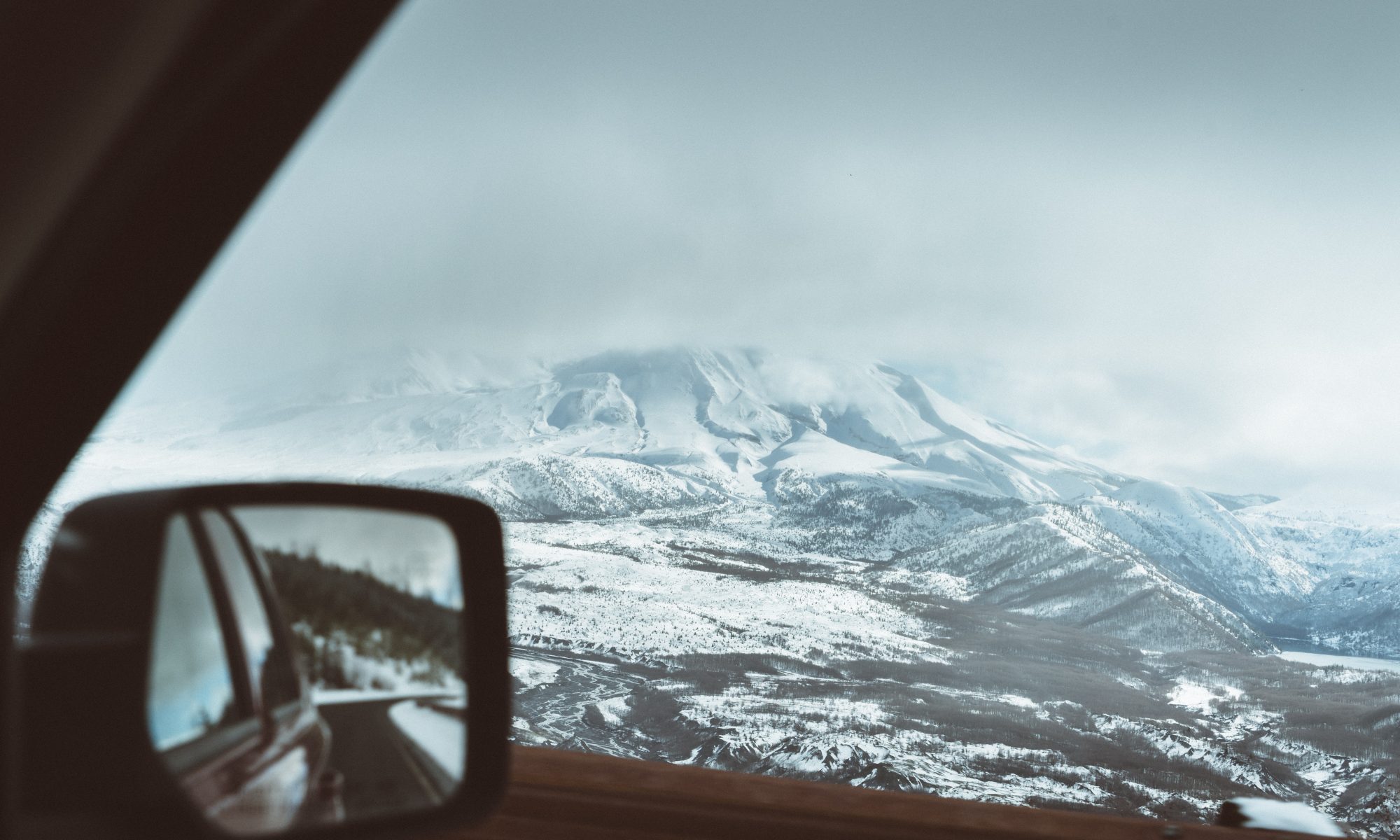 Skiers Over New Year Prepare for a £450 Wipeout at the Car Hire Rental Desk. Photo by Adrian - Unsplash - taken in Mont Saint Helens, USA.