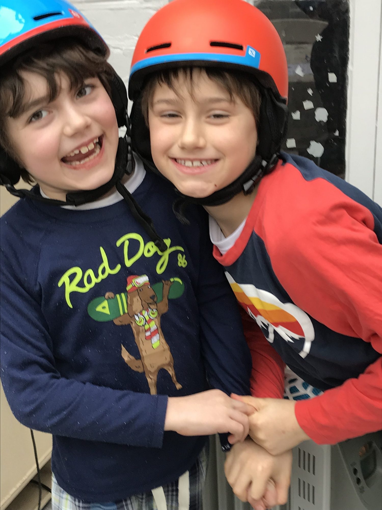 The boys are trying their helmets. The blue helmet is not well suited in the head, but it does work still when applied correctly, here they were mocking around! Photo by The-Ski-Guru.