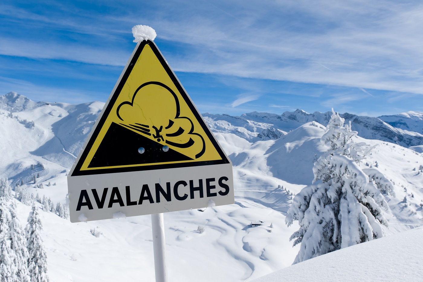 Avalanche sign in winter Alps with snow. One dead and three missing in the Verbier area.