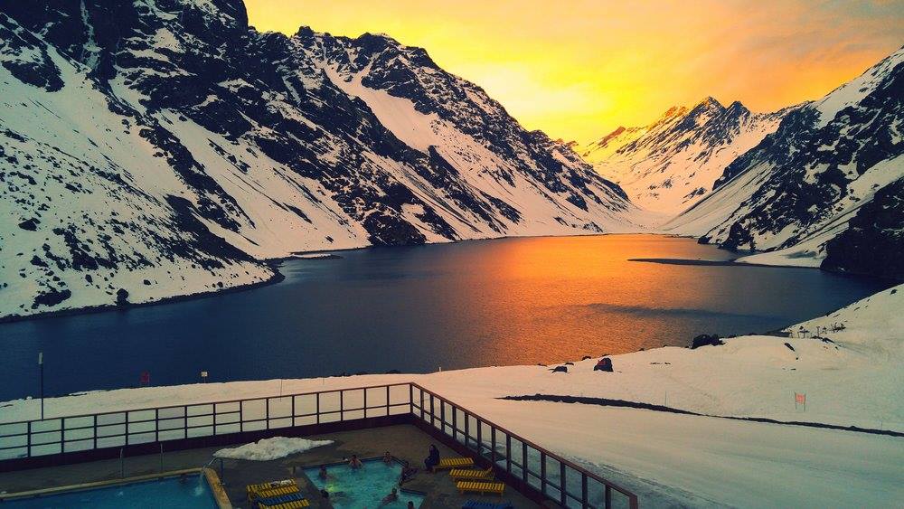 Portillo at sunset - Lake Inca and the Tres Hermanos in the background - room with a view! Photo by Ski Portillo. Focus on South American Ski Resorts- High Andes: Valle Nevado, Portillo and Las Leñas – Chile and Argentina