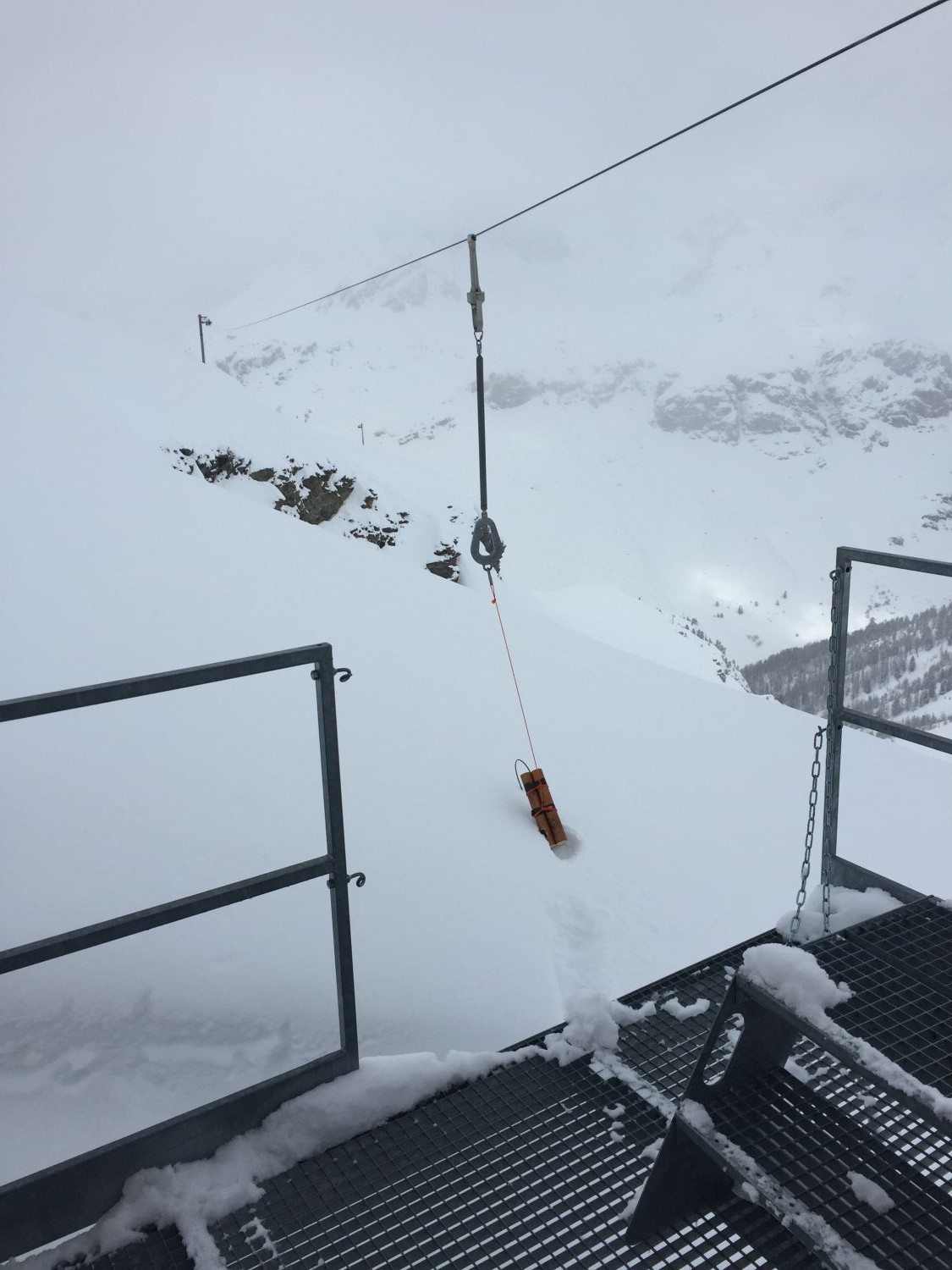 A catex in its rail out of the gare. High prone avalanche terrain