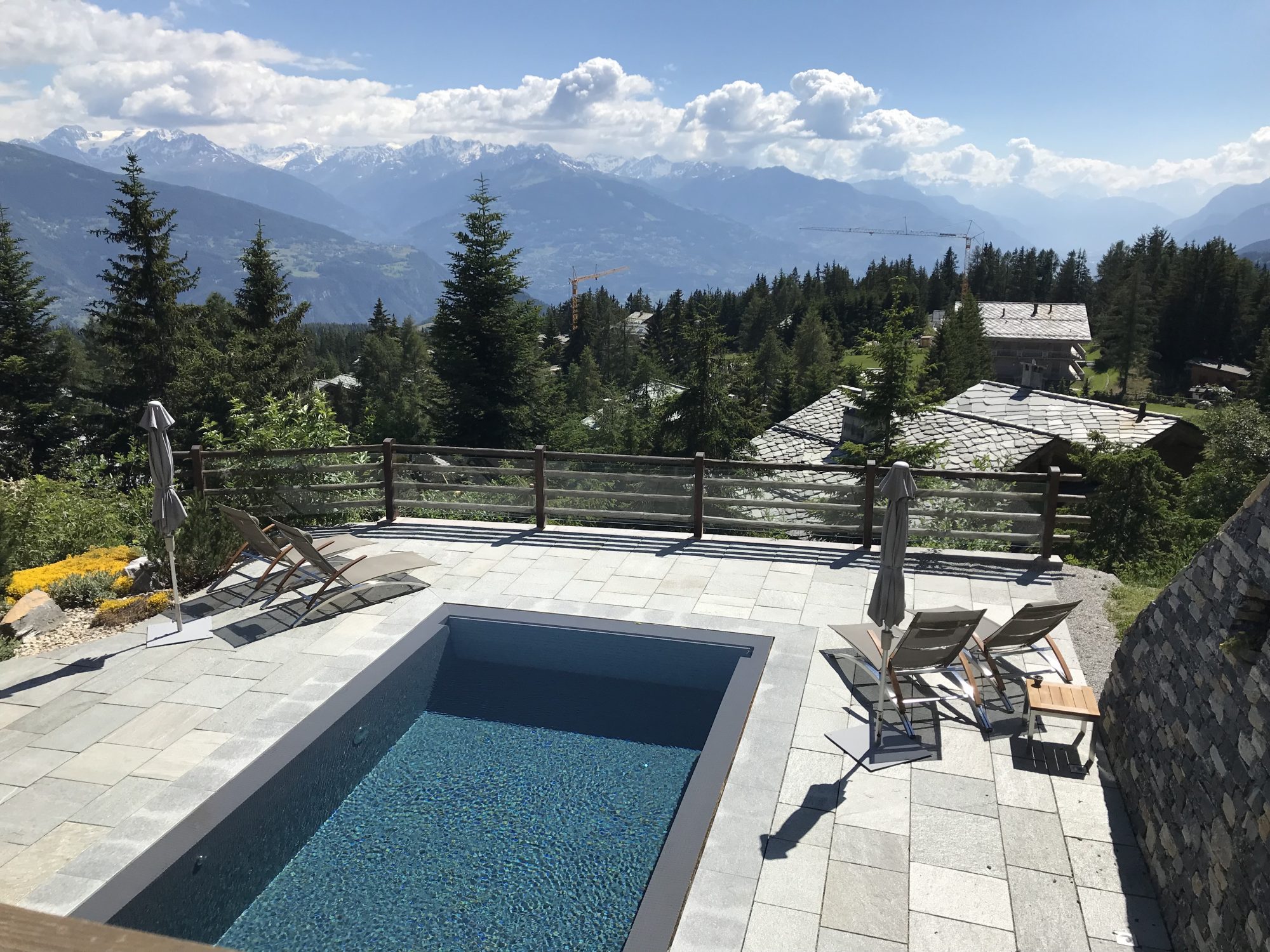 The exterior pool at Le Crans with the views of the Valaissane mountains. 