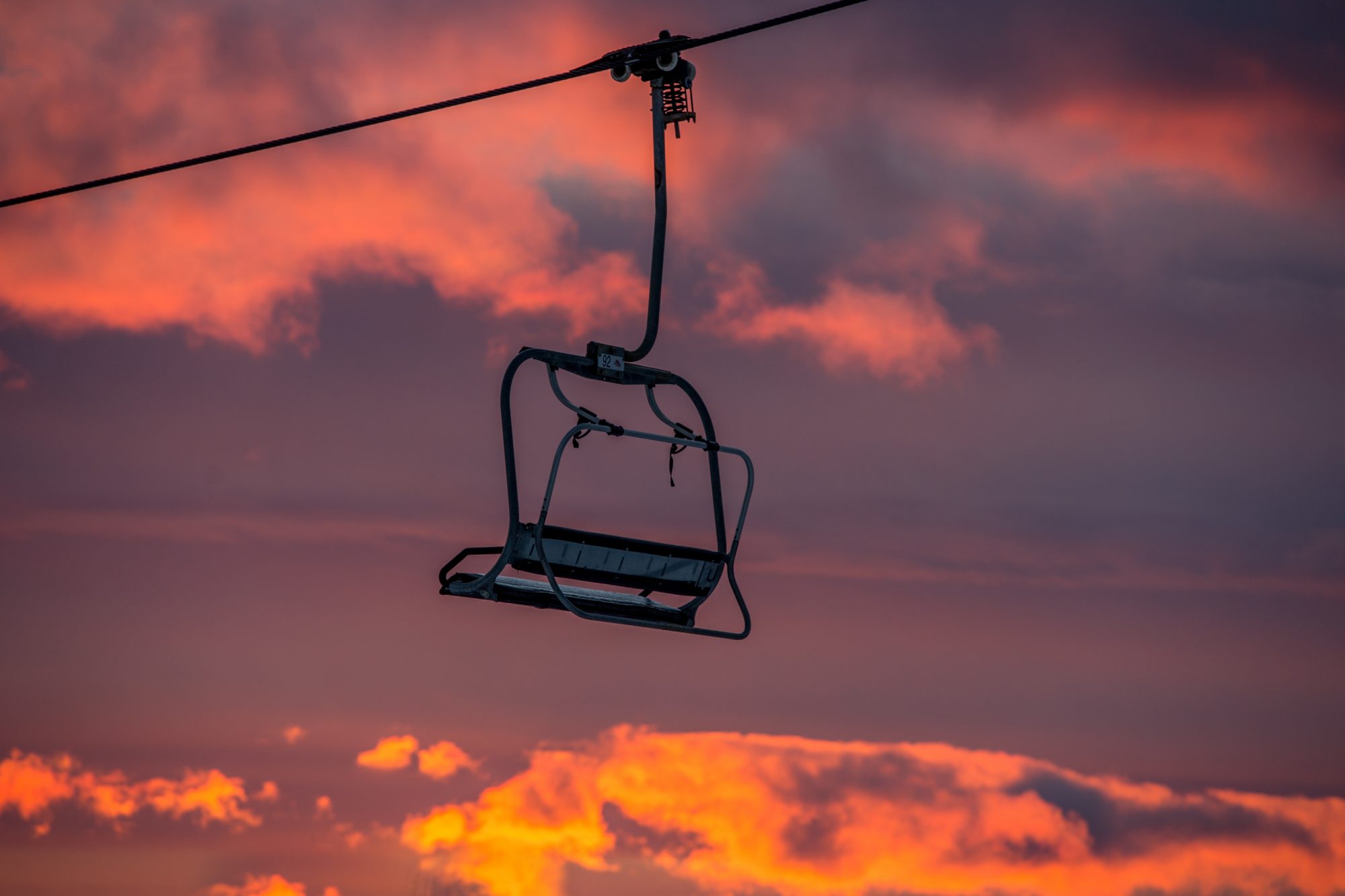 A sunset and a lone chair at Mount Snow. Peak Resorts. 