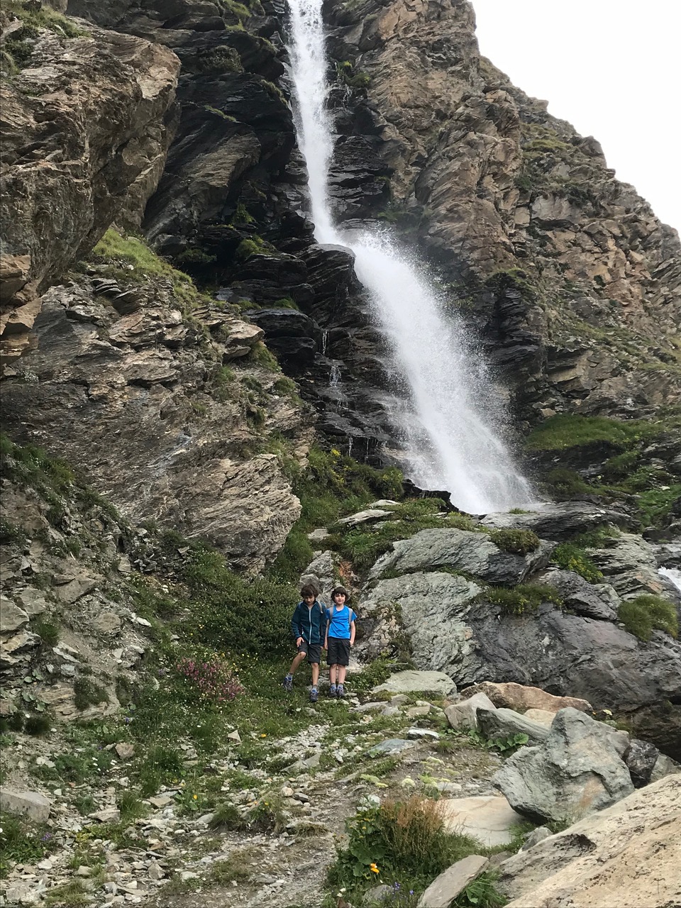 My two boys by the waterfall in the way up to the face of the Monte Cervino. A trekking day with the family in Cervinia. Photo: The-Ski-Guru.