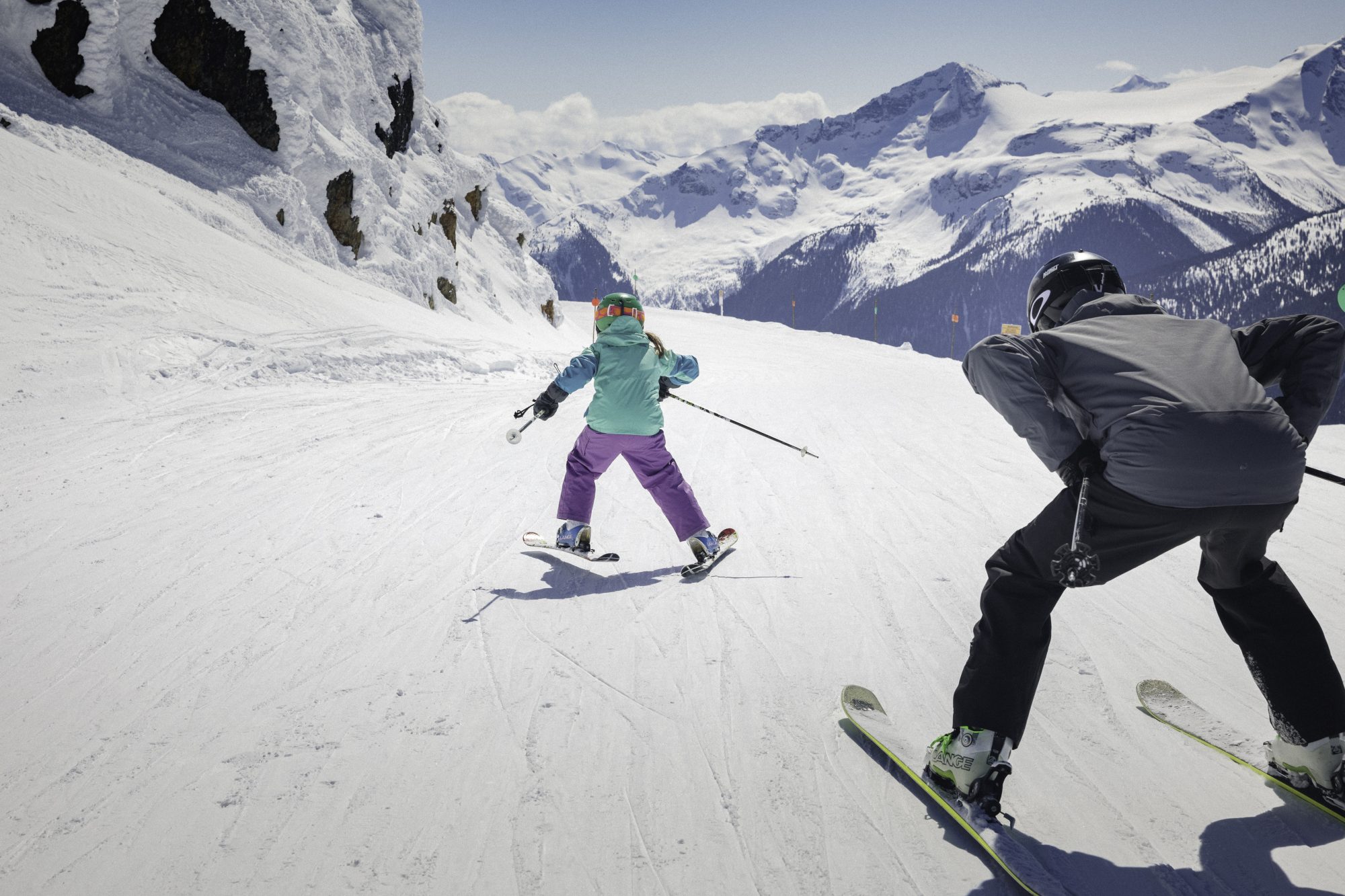 Father and daughter ski along groomed trail on top of the mountain in Whistler Blackcomb. Photo: Robin O'Neill- Whistler Blackcomb- Vail Resorts. New investments in Whistler Blackcomb to enhance the guest experience will be ready for the 2018-19 ski season.