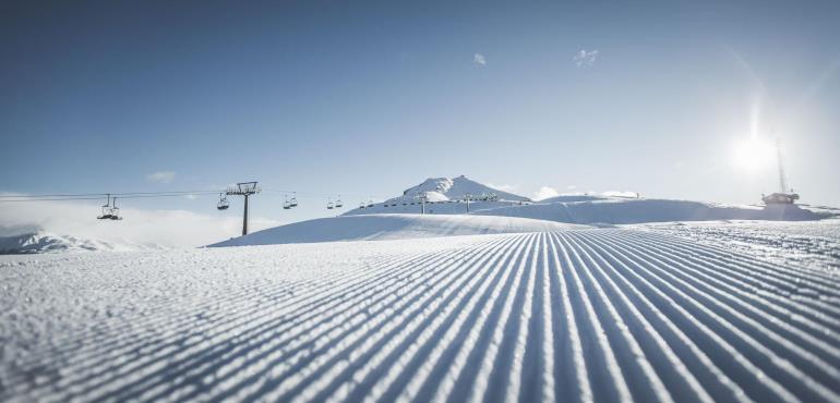 A corduroy piste at 3 Peaks Dolomites ski area - Copyright: 3 Peaks Dolomites. 3 Peaks Dolomites will link its resort to Östirol in Austria for the 21/22 ski season .