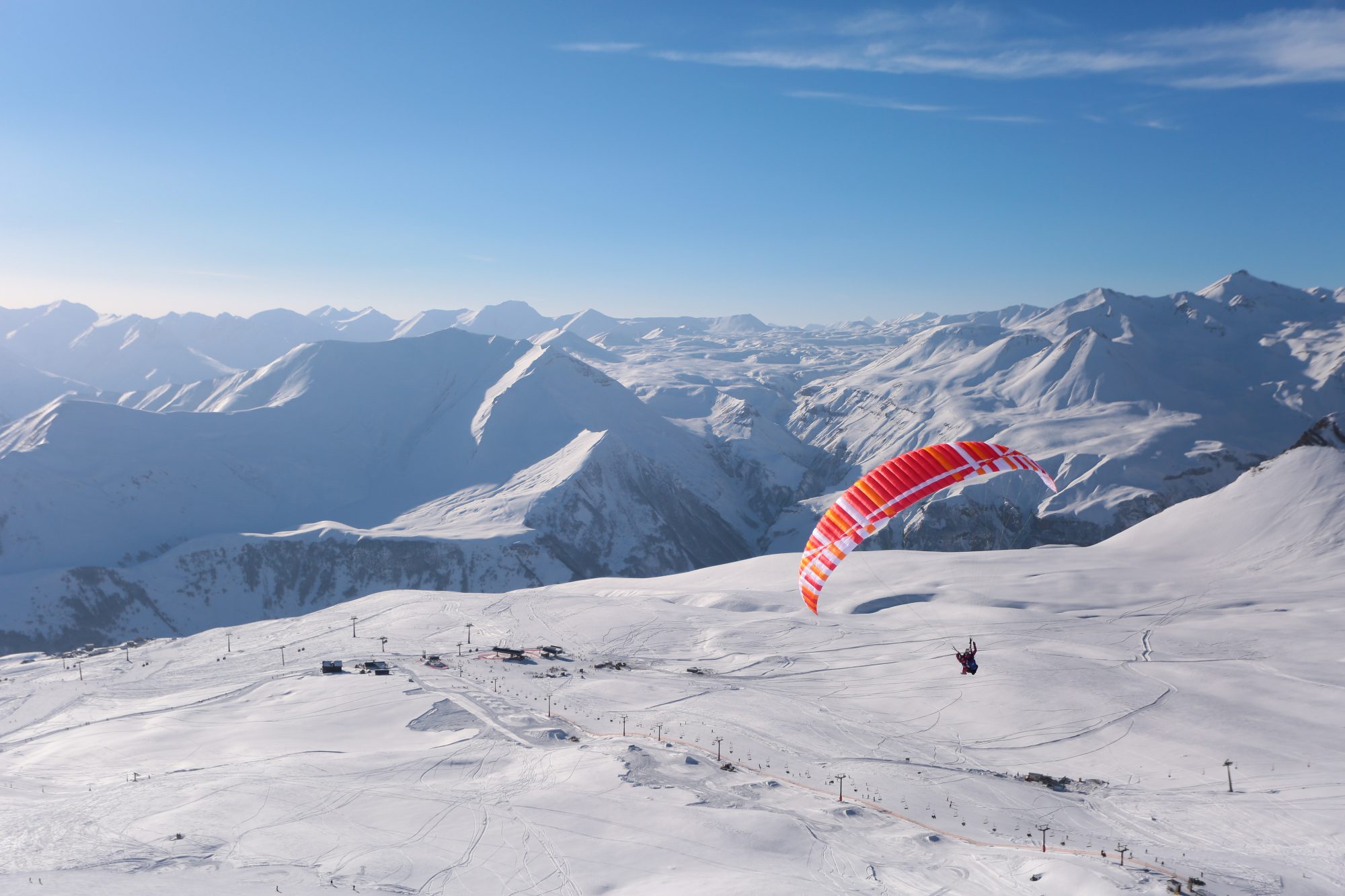 A parapente flying over the slopes of Gudauri Ski Resort. Photo: Mountain Resorts of Georgia. The ski resort Gudauri is rebuilding one lift and adding six new lifts by Doppelmayr and Poma. 