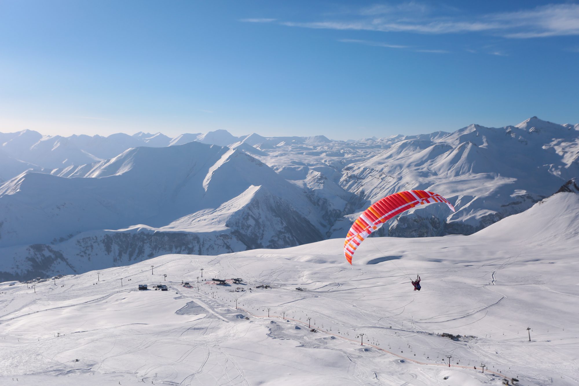 A parapente flying over the slopes of Gudauri Ski Resort. Photo: Mountain Resorts of Georgia. The ski resort Gudauri is rebuilding one lift and adding six new lifts by Doppelmayr and Poma.