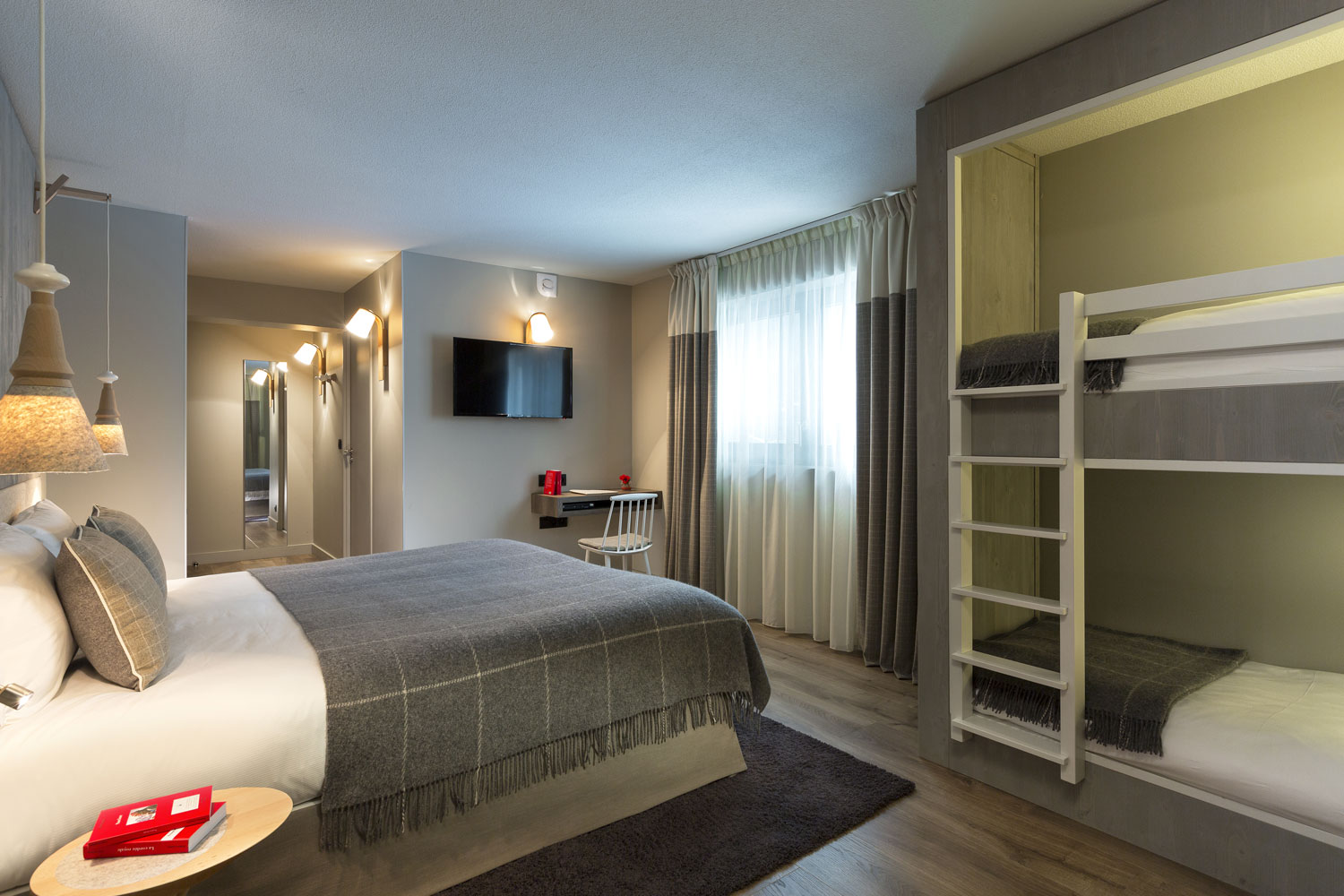 A family room at L'Héliopic, decorated in earth tones. Review of L’Héliopic Hotel Sweet & Spa in Chamonix.