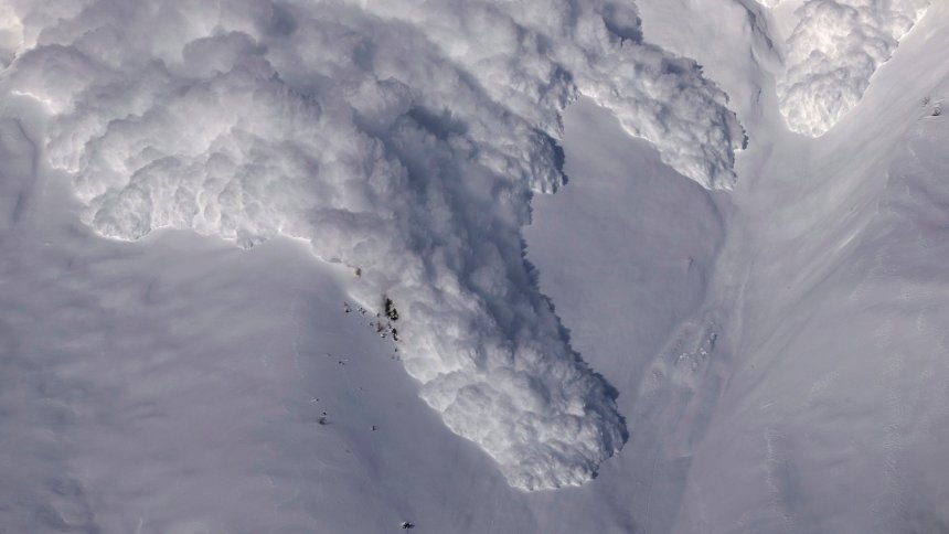 An artificially triggered avalanche thunders down a mountain side at the Vallee de la Sionne in Anzere near Sion, February 3, 2015. The "White Season" in Europe and the Big Snowstorms