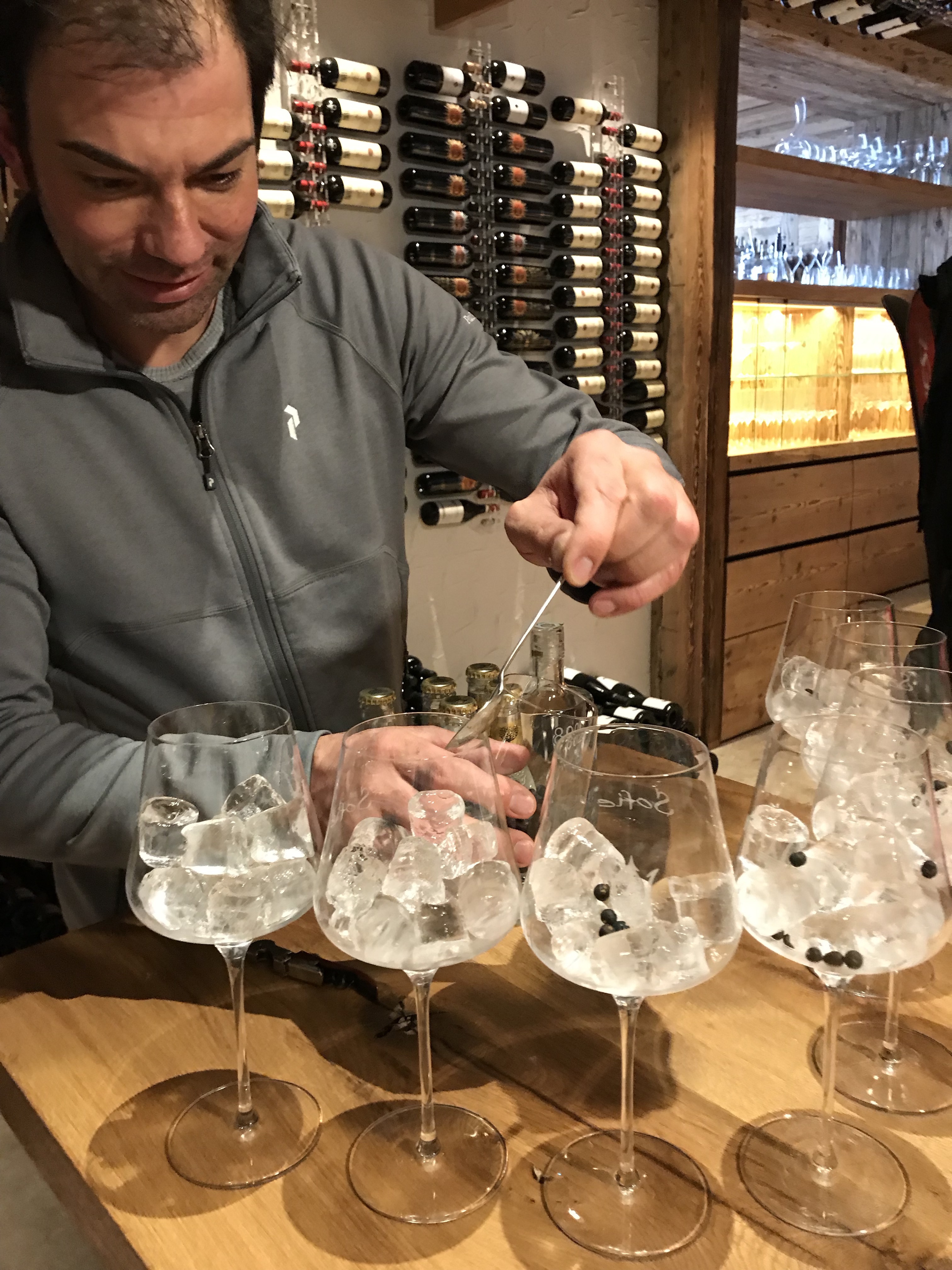 Markus serving his 8025 gin in our small tasting. The group tasting the 8025 gin in the cave of Baita Sofie in Seceda. Photo: Claudia Rier. Lunch at Baita Sofie in Seceda, Val Gardena, Dolomiti Superski, Sudtirol.
