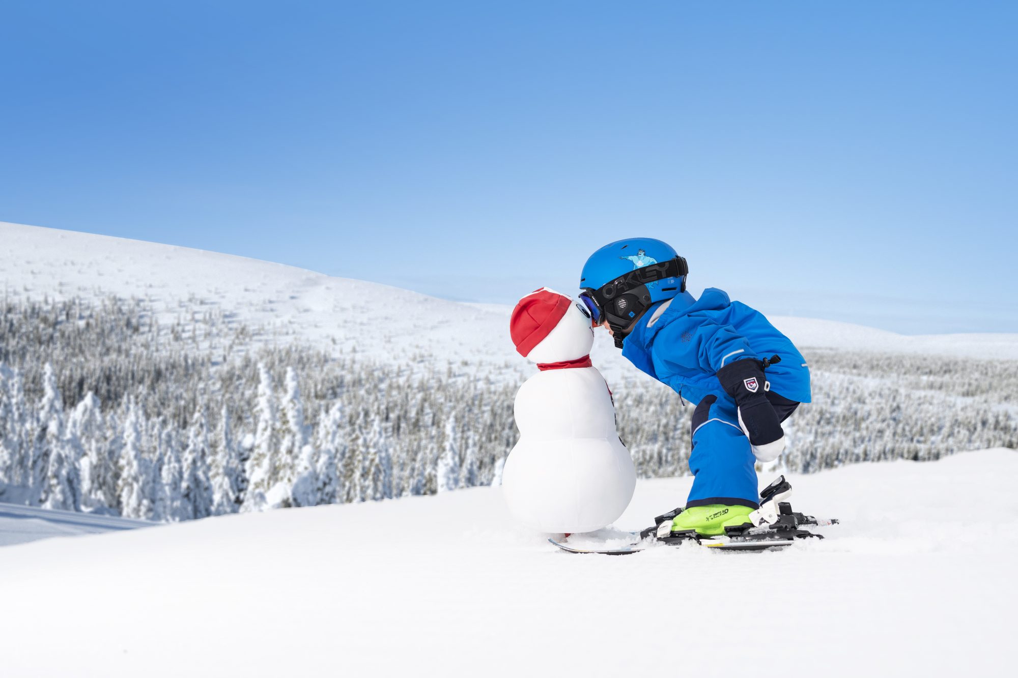 A kid kisses a snowman in the Valle of Salen. Photo Courtesy: SkiStaar. How can we envision ski resorts opening with social distancing for the 2020-21 ski season?