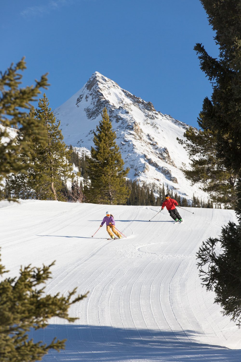 Skiers coming down the front of the mountain with the Butte on the background. Photo: Taylor Ahearn/CBMR. Final Record of Decision Published for Teocalli Drainage Expansion Project.