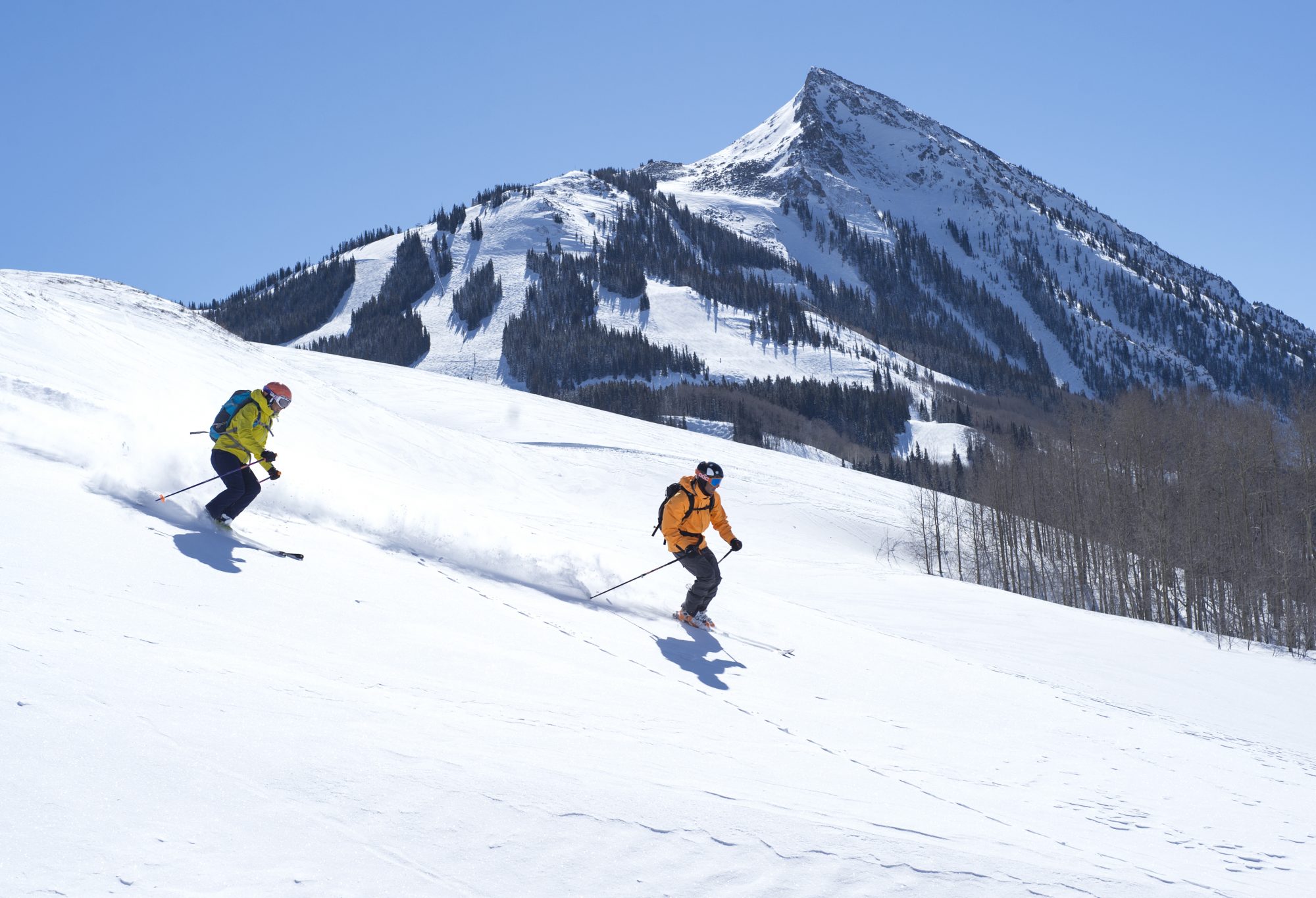 Skiers down the easy slopes on the side of the mountain, with great views of the Butte. Photo: Tom Stillo/CBMR. Final Record of Decision Published for Teocalli Drainage Expansion Project.
