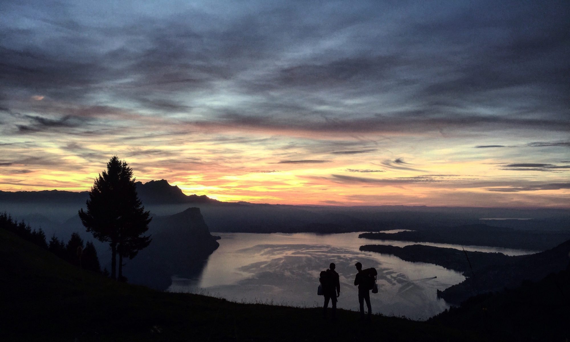 Some hikers in Lake Lucerne. Photo by Jon- Unsplash. NATURAL HAZARDS : Camping in Switzerland carries certain risks.