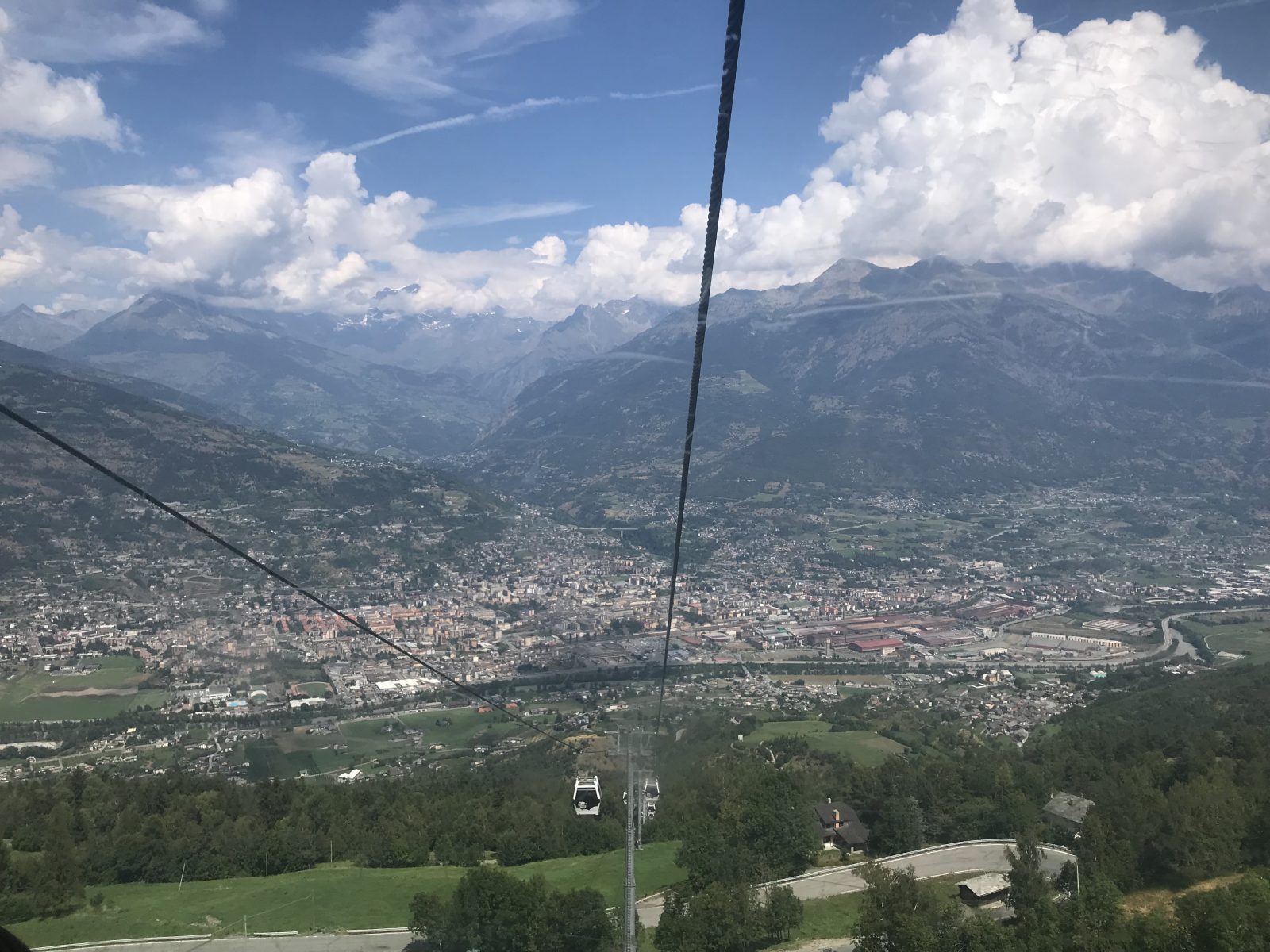 Going up the Pila lift with views of Aosta. Photo: The-Ski-Guru. Our summer in the mountains – one week in Courmayeur.