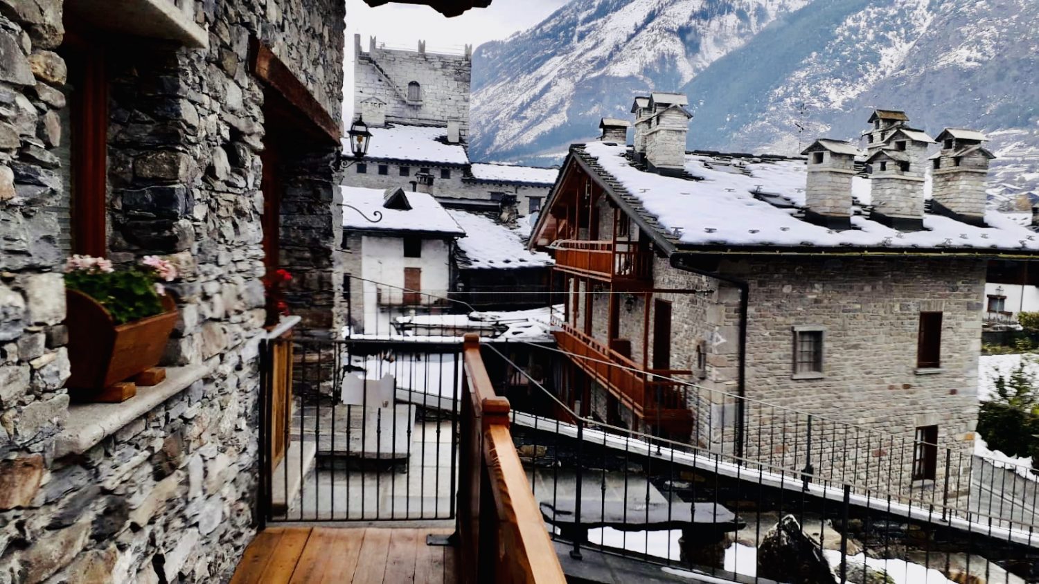 The side view of the front balcony at Il Cuore della Valdigne. Our Ski Chalet For Rent. On the picture you can see La Tour d'Archet, that was the house of the Count of Savoy when visiting Aosta, where he was stopping on the way. 