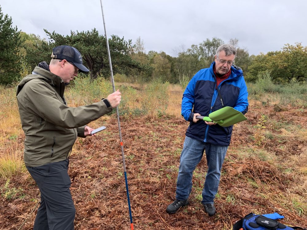 Probe is in, now is the time to start shovelling. Chris is showing us how to prepare the shovel on this Henry's Avalanche Talk course. Rob is holding the probe. If thinking in going off-piste this season, you MUST be safe aware.