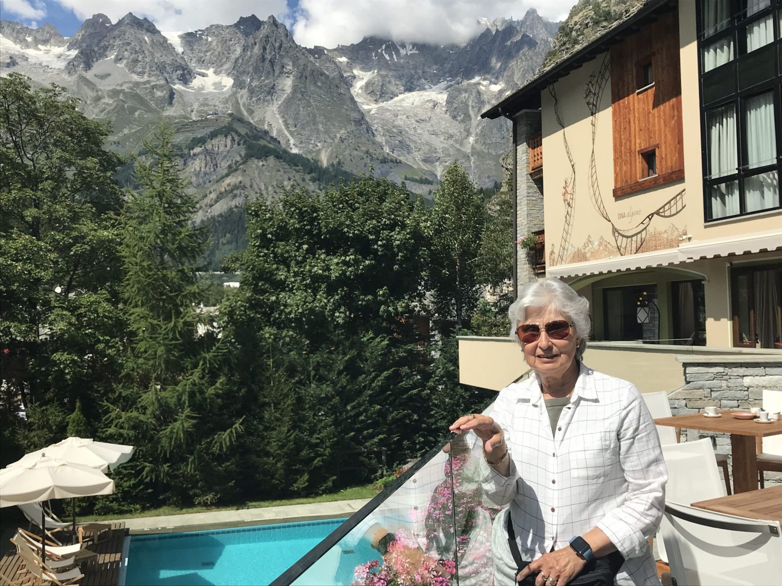 Enjoying the sunny afternoon with the coffee and cake at the terrace of the Gran Baita. My experience of buying a home in the Italian Alps.