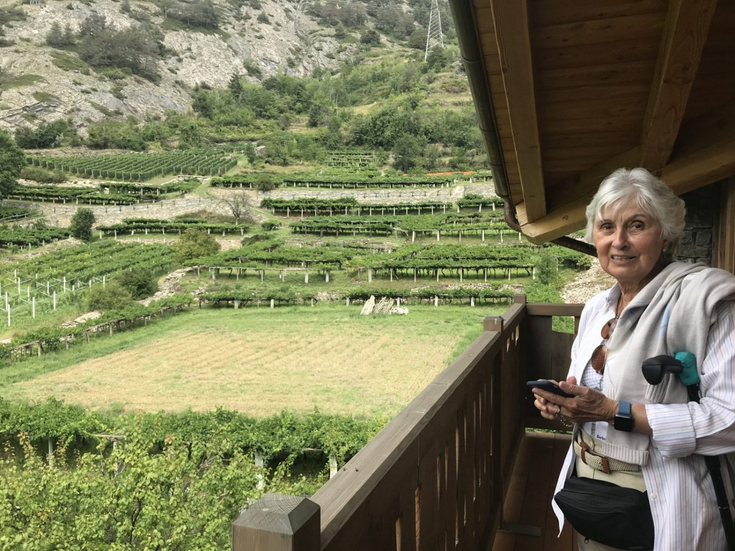 My mother poses in the balcony of this apartment in Villair de Morgex, surrounded by vinyeards. My experience of buying a home in the Italian Alps.