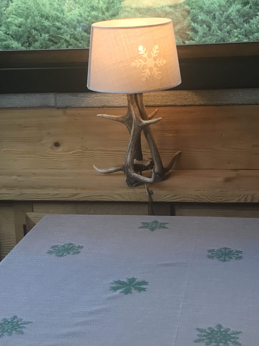 Detail of the tablecloth and wall lamp at the restaurant of the Gran Baita. My experience of buying a home in the Italian Alps.