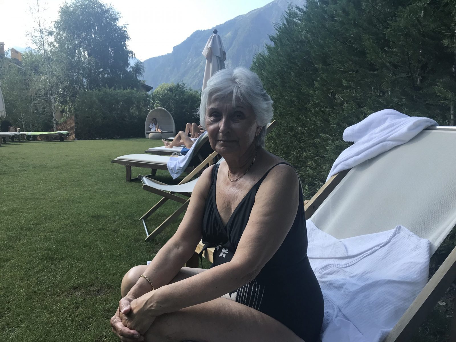 My mum at the pool area of the Gran Baita hotel. My experience of buying a home in the Italian Alps.