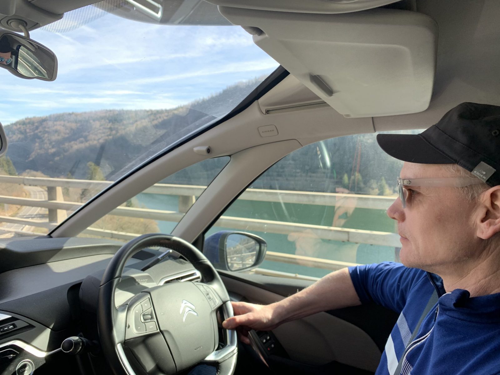 My husband driving over a viaduct near Nantua. Our half term ski-safari holiday based in the Valdigne of Aosta Valley- Courmayeur, Pila and La Thuile.