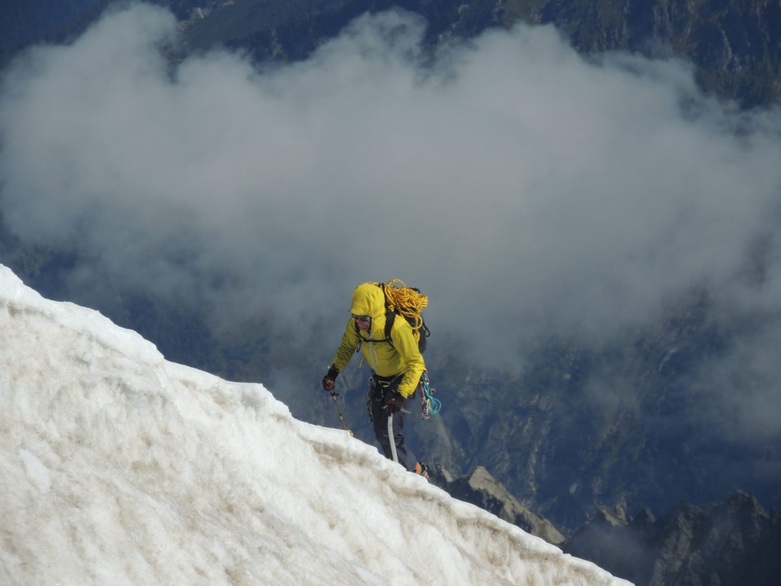 A climber seen from the terrace of the Aiguille du Midi. I just like this picture with the clouds and the guy coming up. Aiguille du Midi vs Punta Helbronner – which one you should do?