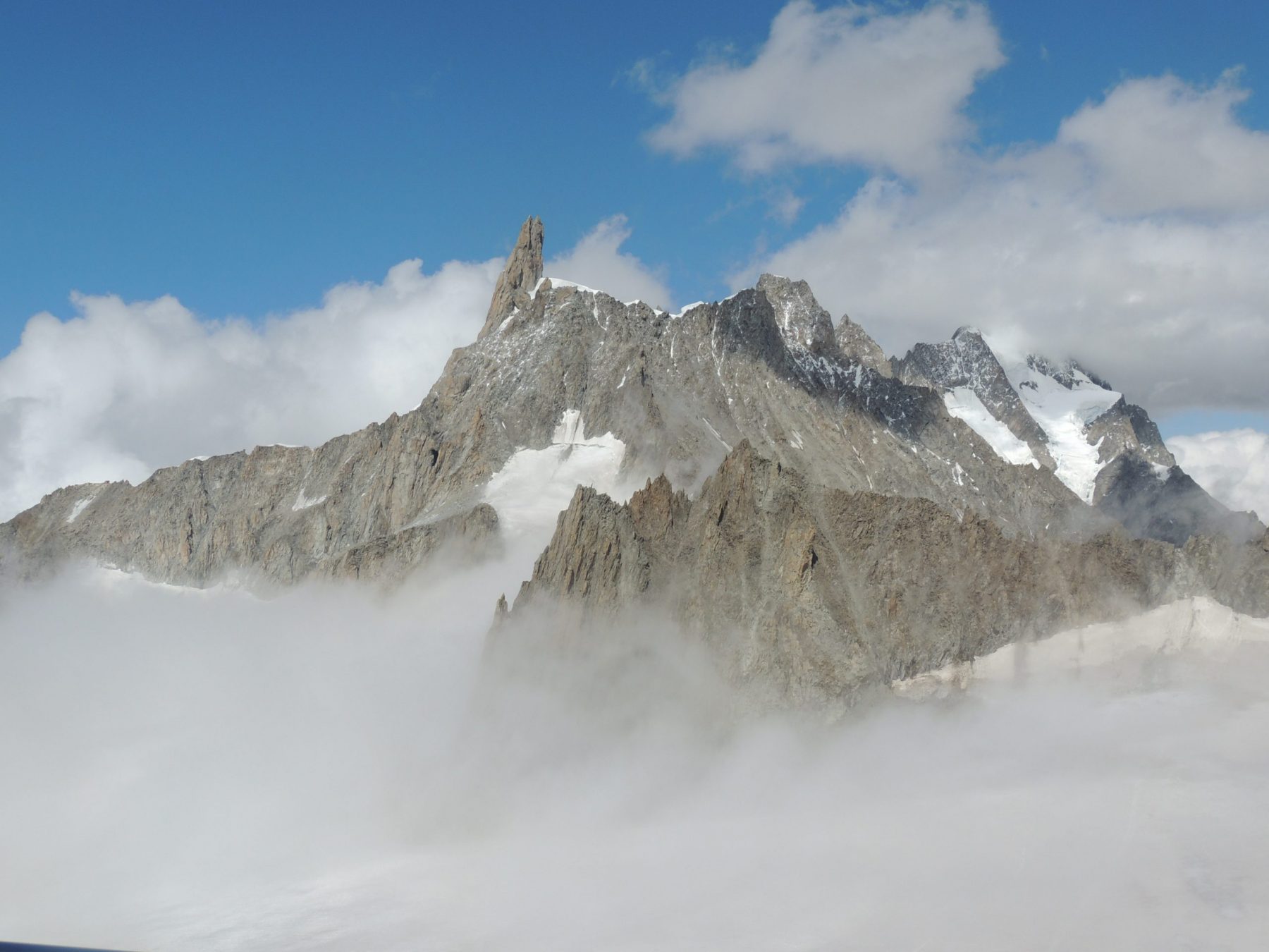 The Dent de Géant between the clouds, I took this photo from the top of Punta Helbronner. Aiguille du Midi vs Punta Helbronner – which one you should do?