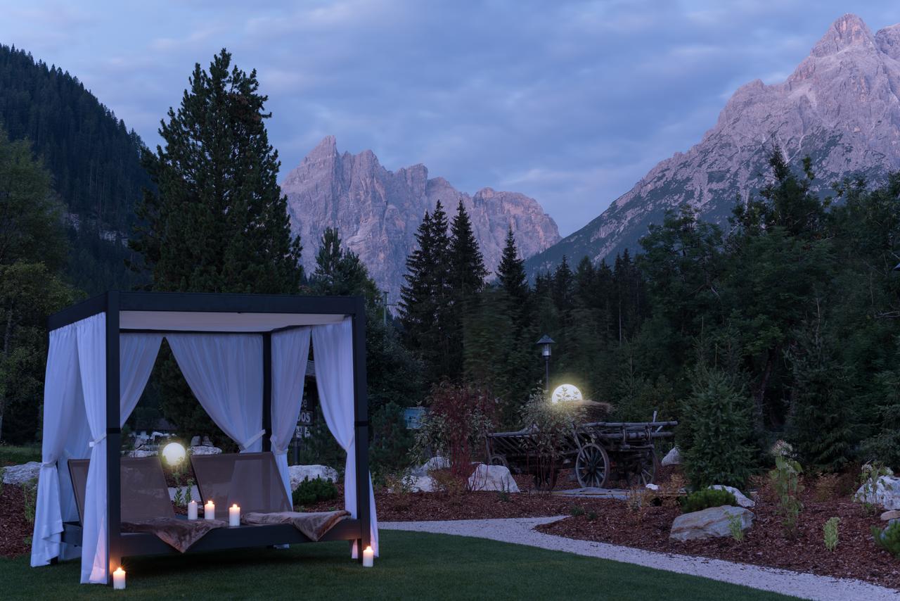 Exterior of the Bad Moss at dusk with the incredible Enrosadira effect (the pink dusk) landscape of the Dolomites. Drei Zinnen will continue with its plan to install the Helmjet Sexten 10-seater cable car.