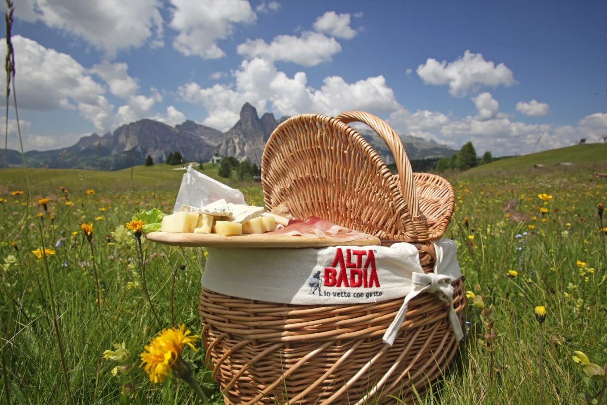 A picnic basket in Alta Badia. You pick them up from the ten rifugios participanting and you get a blanket with it to choose where to sit down and eat with some amazing views. Photo: Freddy Planinschek. Alta Badia Tourism Board. Planning your summer in the mountains of Alta Badia.