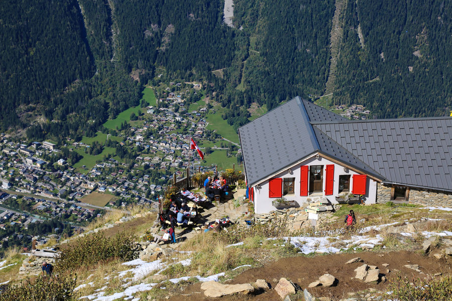 View of the restaurant Plan de l'Aiguille with the town of Chamonix below. Must-Read Guide to Chamonix.