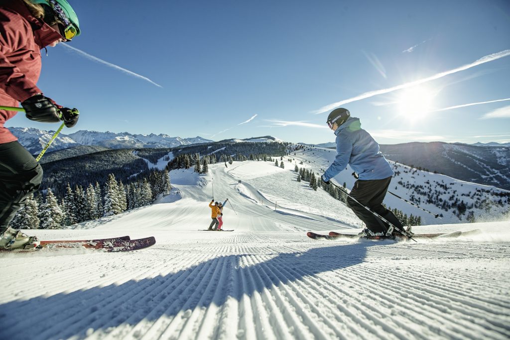 Friends Skiing Groomed Terrain in Vail, CO.. Photo: Daniel Milchev. Vail Resorts. Vail Resorts announces indoor safety protocols for the 2021-22 season.