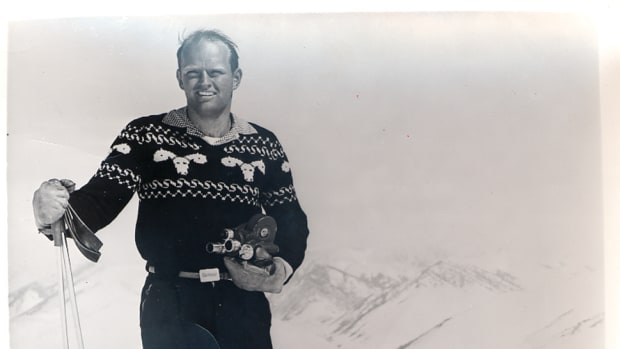 Warren Miller with his camera and his distinctive reindeer jumper. Ski Bum- The Warren Miller Story- A Review.