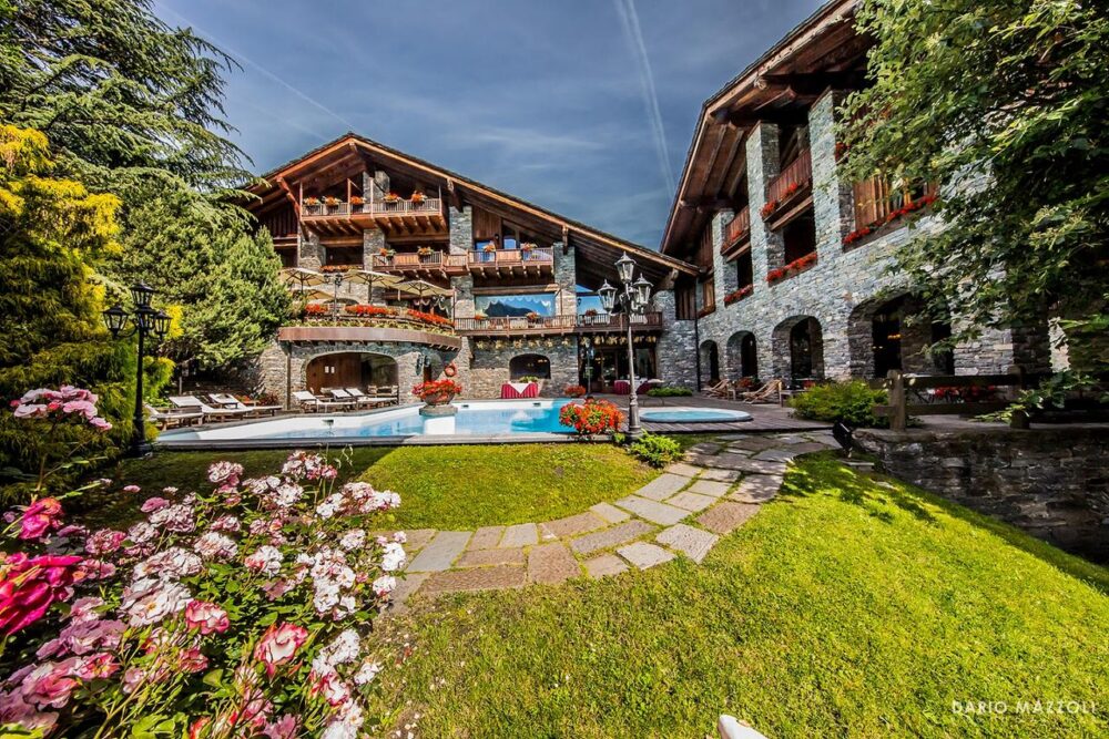 Exterior of the Relais Mont Blanc Hotel and Spa with its beautiful garden and pool. Book your stay at the Relais Mont Blanc Hotel and Spa here. Family trek to Lago d' Arpy, Morgex, AO.